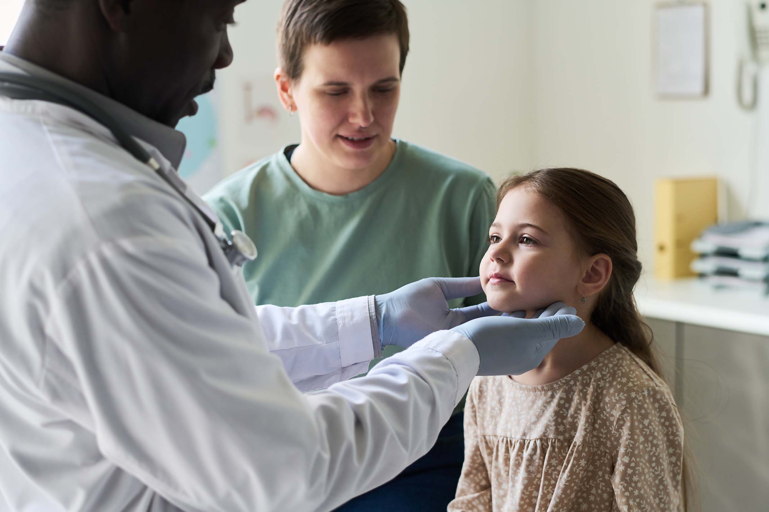 Dr. Paul Spring examining a young patient's ear at SPRING ENT in Metairie, Louisiana